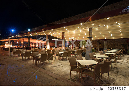 An empty outdoor cafe with tables An empty outdoor cafe with tables 60583317