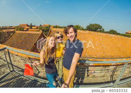 Enjoying vacation in China. Happy family with national chinese flag in Forbidden City. Travel to China with kids concept. Visa free transit 72 hours, 144 hours in China 60583332