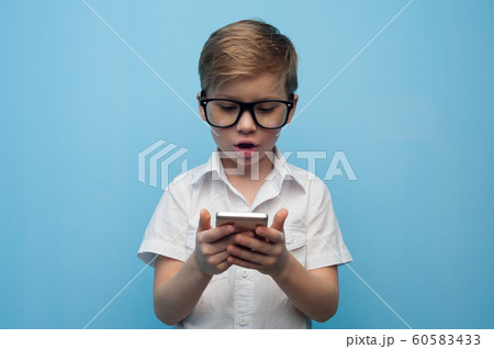 Curious cute little boy in glasses Curious cute little boy in glasses 60583433