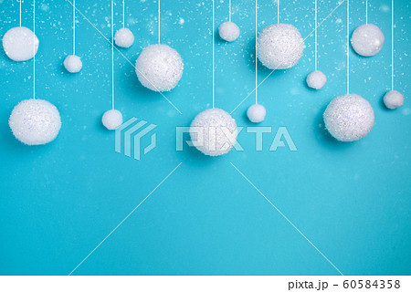 Christmas composition. The concept of a winter festive background, snowfall from white balls on a blue background. Christmas, winter, new year concept. Minimalism flat lay Christmas composition. The concept of a winter festive background, snowfall from white balls on a blue background. Christmas, winter, new year concept. Minimalism flat lay 60584358