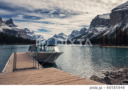Cruise ship tour anchored on wooden dock with Cruise ship tour anchored on wooden dock with 60585946