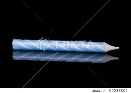 Birthday cake candle isolated on black glass 60588302
