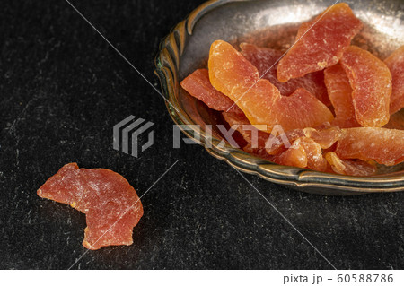 Dried orange papaya on grey stone Dried orange papaya on grey stone 60588786