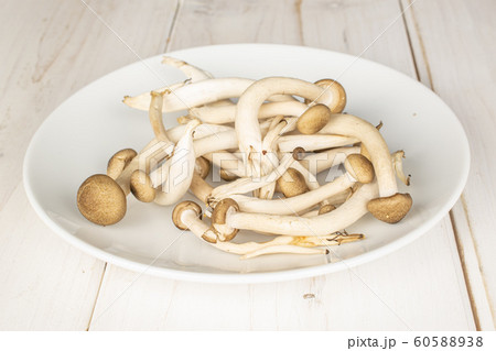 Brown shimeji mushroom on grey wood Brown shimeji mushroom on grey wood 60588938