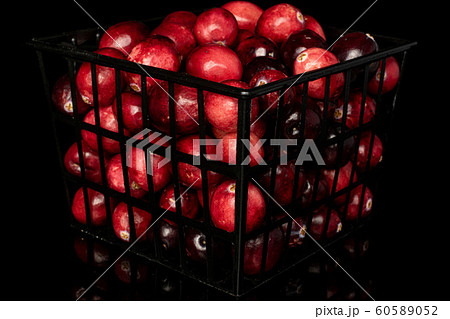 Fresh red cranberry isolated on black glass Fresh red cranberry isolated on black glass 60589052