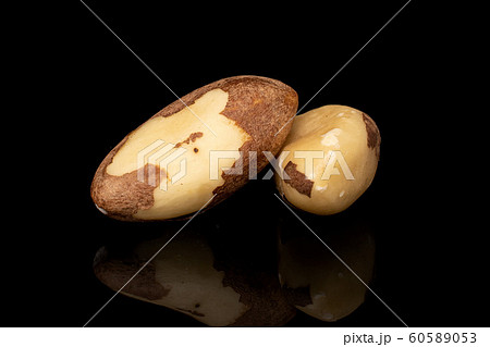 Brown brazil nut isolated on black glass Brown brazil nut isolated on black glass 60589053
