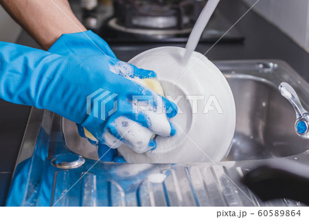 Washing the cup with a dish washing liquid. 60589864