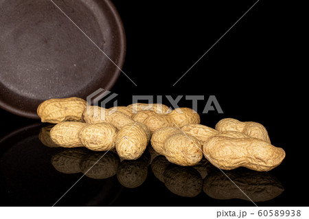 Tasty beige peanut isolated on black glass Tasty beige peanut isolated on black glass 60589938