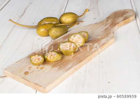 Green pickled caper on grey wood 60589939