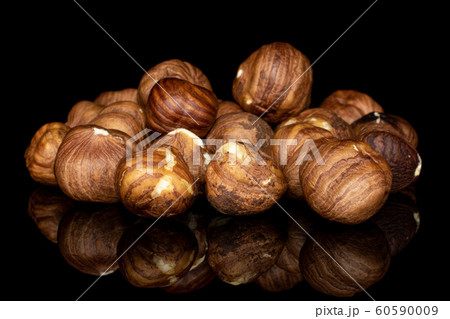 Tasty brown hazelnut isolated on black glass Tasty brown hazelnut isolated on black glass 60590009
