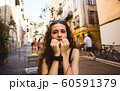 Beautiful caucasian woman smiling. On the streets of old town in Nice, France. 60591379