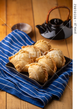 Homemade chicken Curry puffs on wooden table Homemade chicken Curry puffs on wooden table 60591862