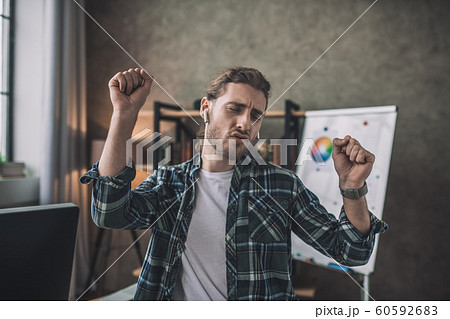 Emotional man dancing while listening to his favourite music Emotional man dancing while listening to his favourite music 60592683