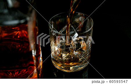 Detail of pouring whiskey into glass 60593547