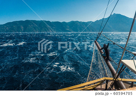 Waves on the sea and the mast of the ship in Greece 60594705