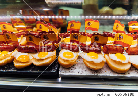Spanish burger with omelet and souvenir flag of Spain in the market of San Miguel Spanish burger with omelet and souvenir flag of Spain in the market of San Miguel 60596299