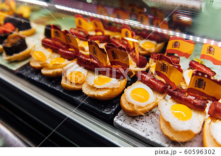Spanish burger with omelet and souvenir flag of Spain in the market of San Miguel Spanish burger with omelet and souvenir flag of Spain in the market of San Miguel 60596302