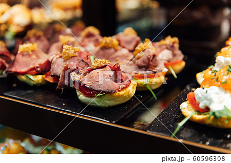 A wide variety of traditional tapas with seafood in Spain at the San Miguel market A wide variety of traditional tapas with seafood in Spain at the San Miguel market 60596308