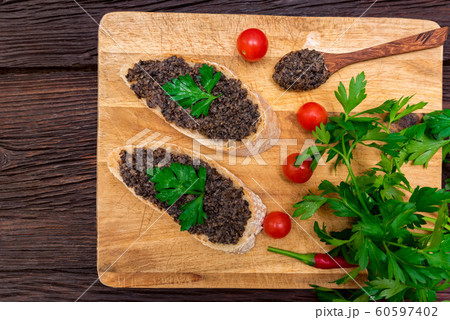Fresh tasty bruschetta with truffle sauce, chili, parsley and tomates. Top view Fresh tasty bruschetta with truffle sauce, chili, parsley and tomates. Top view 60597402
