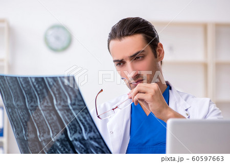 Young male doctor working in the clinic Young male doctor working in the clinic 60597663