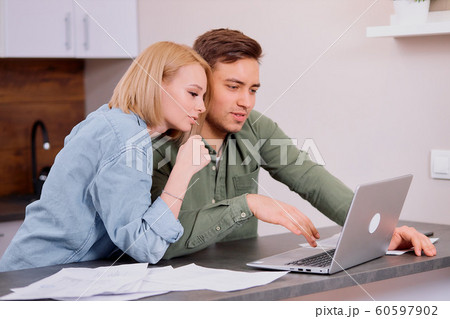 beautiful couple look at screen of laptop beautiful couple look at screen of laptop 60597902