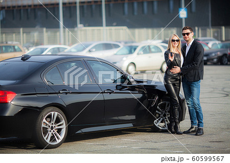 The successful visit to the dealership. Happy young couple chooses and buying a new car for the family 60599567