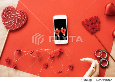 Heart shaped large red and white striped sugar lollipop, wooden hand, phone 60599602