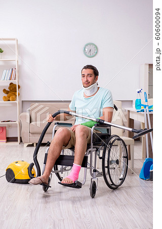 Young man in wheel-chair cleaning the house Young man in wheel-chair cleaning the house 60600094