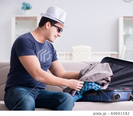 Man with hat preparing for summer vacation 60601582