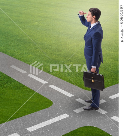 The young businessman at crossroads in uncertainty concept 60601997