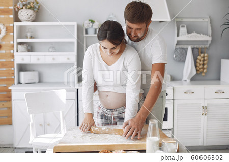 Beautiful couple spend time in a kitchen 60606302