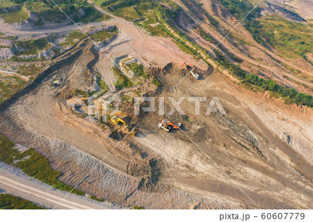 Aerial view of machine excavator trucks dig coal 60607779