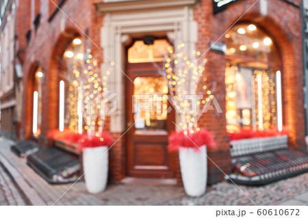 Abstract blur. Street in a Christmas day in an old European town. Lamps garlands, christmas decor and decorations 60610672