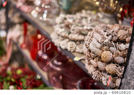 Assortment of European flower shop. Beautiful festive wreath of fresh spruce. Christmas mood. Xmas tree. Bokeh of Garland lights on background Assortment of European flower shop. Beautiful festive wreath of fresh spruce. Christmas mood. Xmas tree. Bokeh of Garland lights on background 60610810