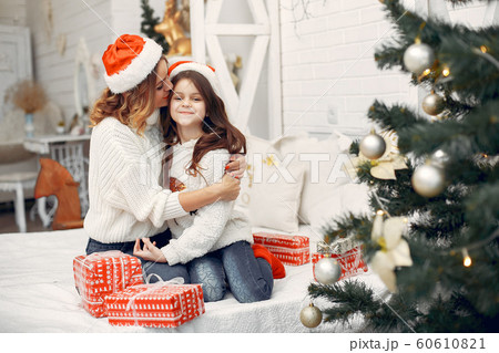 Mother with cute daughter sitting in a room 60610821