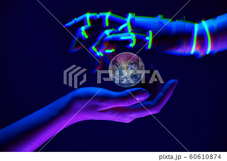 Earth between woman and robot's hands as symbol of partnership between people and technology for savety nature. Elements of this image are furnished by NASA Earth between woman and robot's hands as symbol of partnership between people and technology for savety nature. Elements of this image are furnished by NASA 60610874