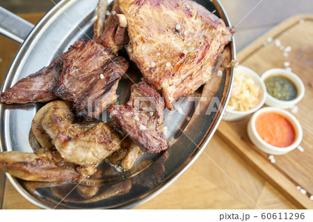 Various grilled meat set heated on coals. Barbecue restaurant menu. Many different food on the table. Dinner party or Banquet Various grilled meat set heated on coals. Barbecue restaurant menu. Many different food on the table. Dinner party or Banquet 60611296