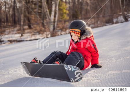 Little cute boy snowboarding. Activities for children in winter. Children's winter sport. Lifestyle 60611666