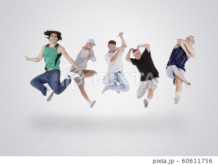 Group of young teenagers jumping over white Group of young teenagers jumping over white 60611756