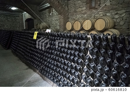 Ancient wine cellar with oak barrels and shelves Ancient wine cellar with oak barrels and shelves 60616810