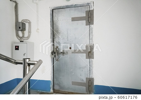 Old metal door locked in an industrial room 60617176