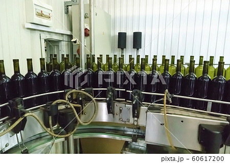 Bottling and sealing conveyor line at winery Bottling and sealing conveyor line at winery 60617200