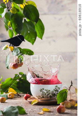 Splash in a porcelain cup of red tea. Tea ceremony. Painted china. In a room decorated with green 60618910
