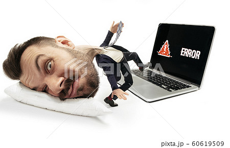 Big head on small body lying on the pillow 60619509