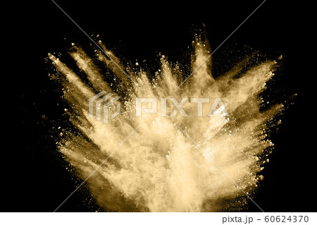 Golden powder explosion on black background. 60624370