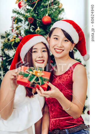 Two Asian girls teen in happiness Christmas New Year Eve Gift 60624940