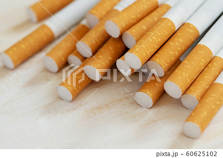 image of several commercially made pile cigarette on white wooden image of several commercially made pile cigarette on white wooden 60625102