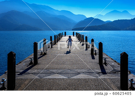 Little girl running on pathway in Sun moon lake. 60625405