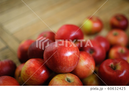 Sweet ripe red juicy apples on wooden background, healthy eating and vegetarian lifestyle concepts. 60632425