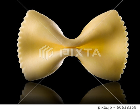 Macro photo of yellow farfalle pasta isolated on black with clipping path 60633359